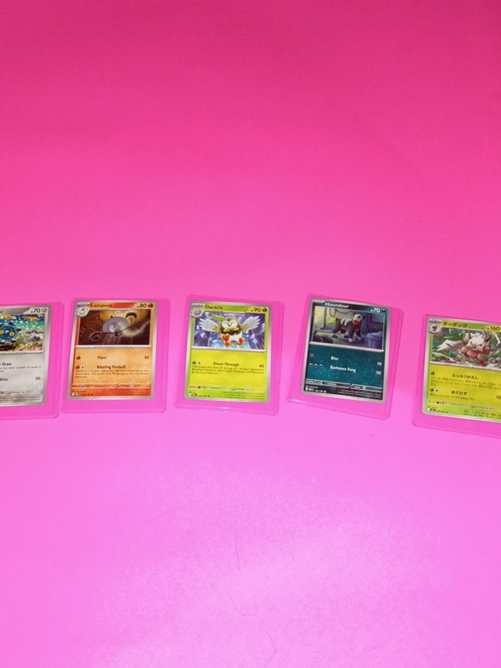 Pokemon Trading Cards on Bright Pink Background